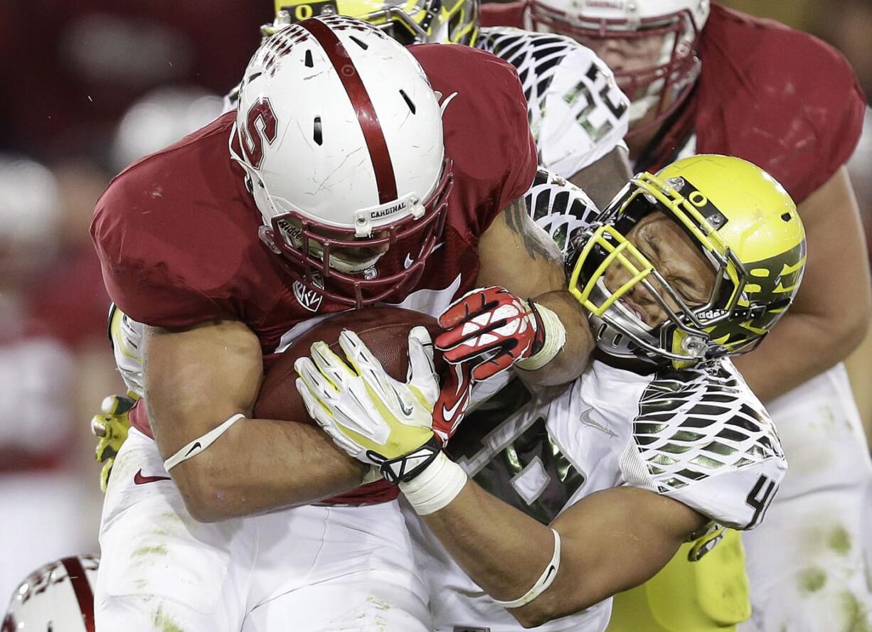 Stanford running back Tyler Gaffney, left, runs against Oregon linebacker Rodney Hardrick (48) during the second quarter of an NCAA college football game in Stanford, Calif., Thursday, Nov. 7, 2013.