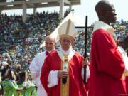 Pope Francis celebrates a mass in the Barthelemy Boganda Stadium, in Bangui, Central African Republic, on Monday. The pontiff is on his way back to Italy after a two-day visit to Central African Republic. After a final Mass at the sports stadium in Bangui, the pope&#039;s motorcade headed to the airport where his plane has now taken off.