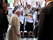 People cheer Pope Francis as he meets with Director-General of the United Nations Office at Nairobi Sahle-Work Zewde, right, upon his arrival at the United Nations regional office, in Nairobi, Kenya, on Thursday.