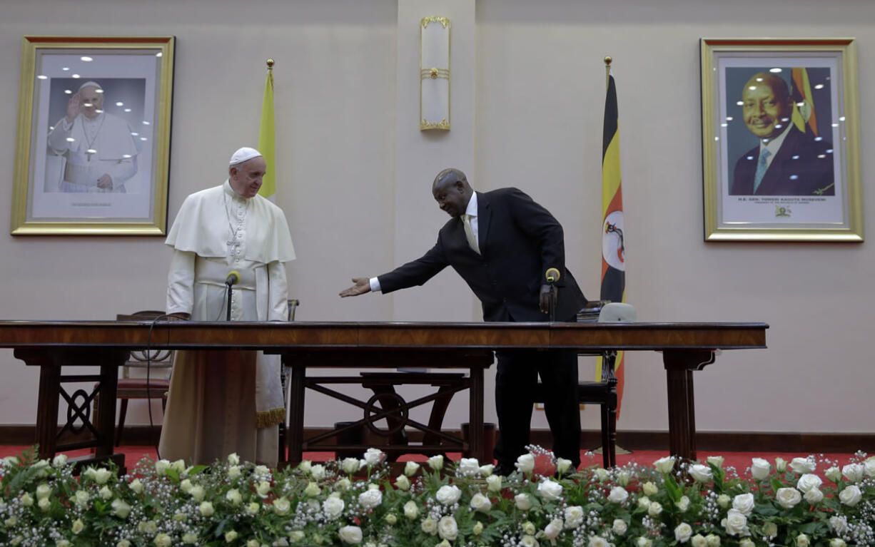 Pope Francis is greeted by Uganda&#039;s President Yoweri Kaguta Museveni at the State House, in Entebbe, Uganda, Friday, Nov. 27, 2015. Pope Francis is in Africa for a six-day visit that is taking him to Kenya, Uganda and the Central African Republic.