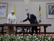 Pope Francis is greeted by Uganda&#039;s President Yoweri Kaguta Museveni at the State House, in Entebbe, Uganda, Friday, Nov. 27, 2015. Pope Francis is in Africa for a six-day visit that is taking him to Kenya, Uganda and the Central African Republic.