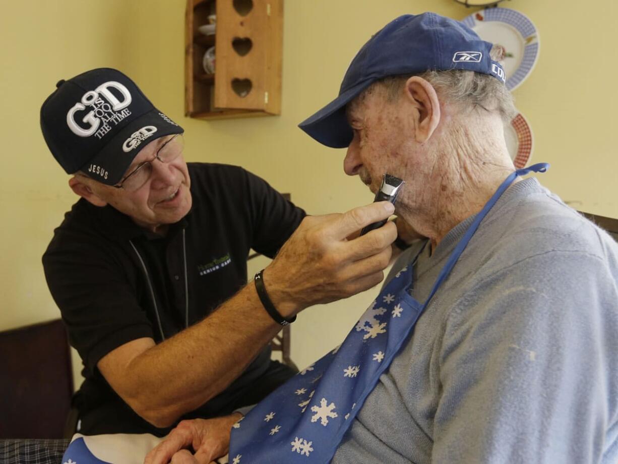 Warren Manchess, 74, left, shaves Paul Gregoline, 92.