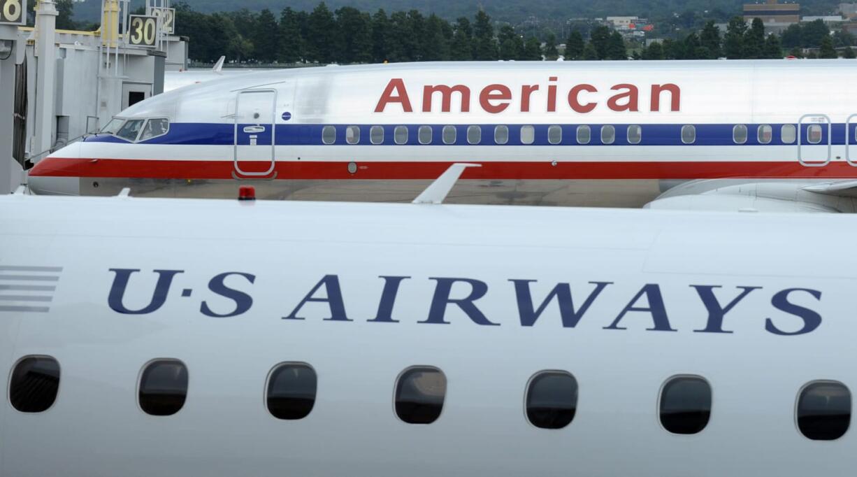 An American Airlines plane and a US Airways plane are parked at Washington's Ronald Reagan National Airport.