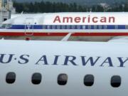 An American Airlines plane and a US Airways plane are parked at Washington's Ronald Reagan National Airport.