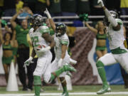 Oregon's Derrick Malone (22) returns an interception for a touchdown against Texas during the second half of the Valero Alamo Bowl NCAA college football game, Monday,  Dec. 30, 2013, in San Antonio.