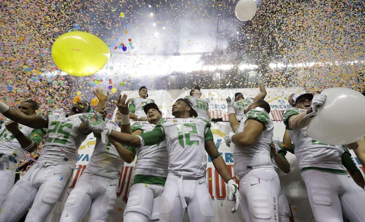 Oregon players celebrate the team's win over Texas in the Valero Alamo Bowl NCAA college football game, Monday,  Dec. 30, 2013, in San Antonio. Oregon won 30-7.