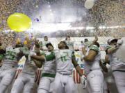 Oregon players celebrate the team's win over Texas in the Valero Alamo Bowl NCAA college football game, Monday,  Dec. 30, 2013, in San Antonio. Oregon won 30-7.