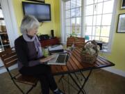 Terri Roberts, mother of Charles Carl Roberts IV, the gunman in the Nickel Mines Amish schoolhouse massacre, works on her computer at her home in Strasburg, Pa.