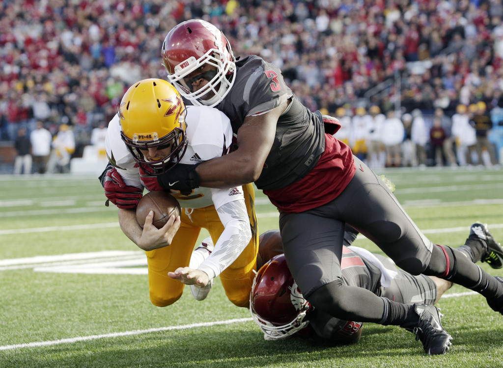 Washington State linebacker Ivan McLennan (3) and Washington State safety Shalom Luani, bottom, bring down Arizona State quarterback Mike Bercovici during the first half of an NCAA college football game, Saturday, Nov. 7, 2015, in Pullman, Wash.