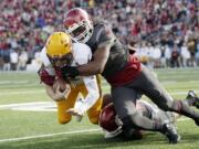 Washington State linebacker Ivan McLennan (3) and Washington State safety Shalom Luani, bottom, bring down Arizona State quarterback Mike Bercovici during the first half of an NCAA college football game, Saturday, Nov. 7, 2015, in Pullman, Wash.