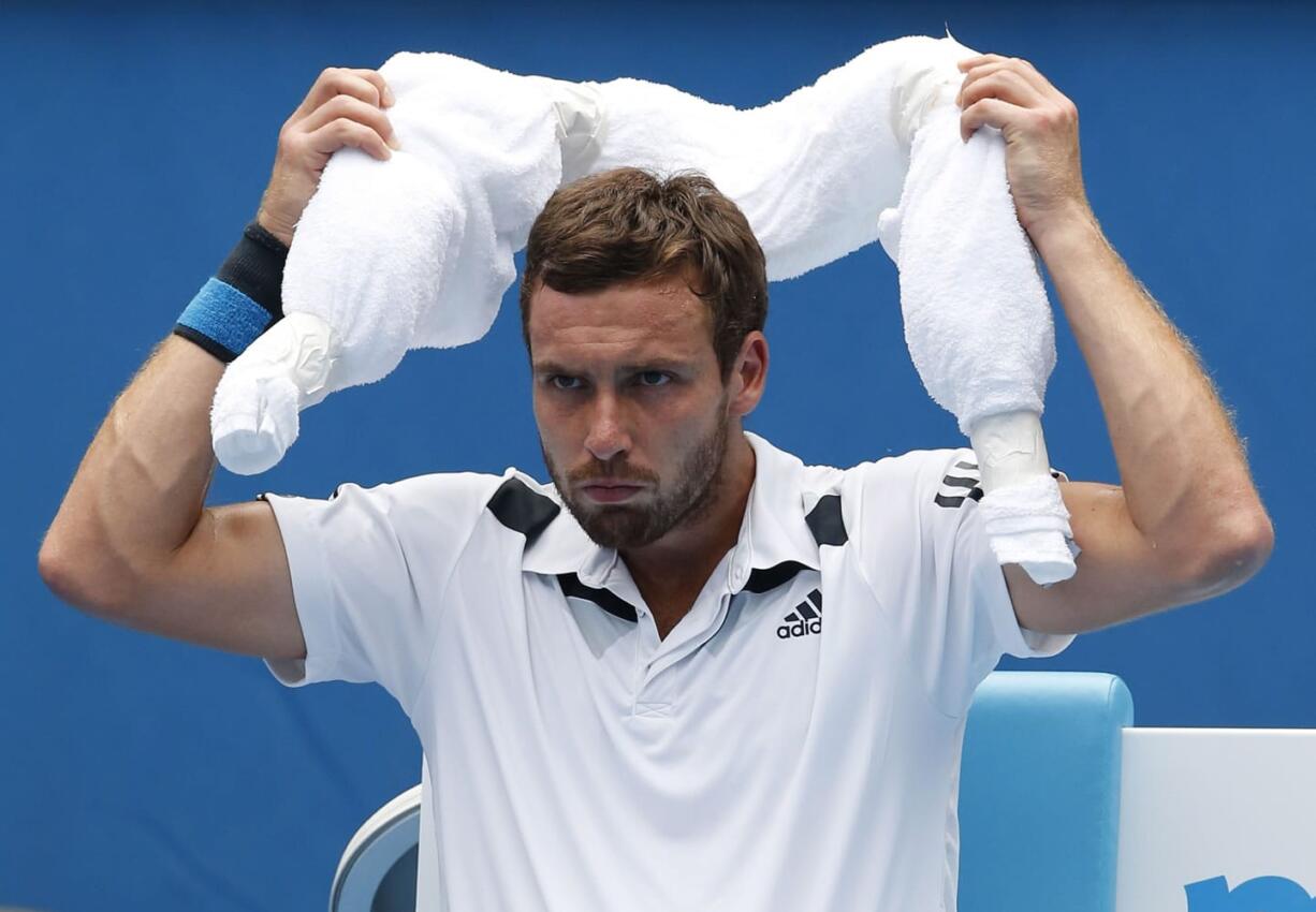 Ernests Gulbis of Latvia puts ice towel around his neck during his second round match against Sam Querrey of the U.S.