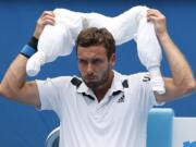 Ernests Gulbis of Latvia puts ice towel around his neck during his second round match against Sam Querrey of the U.S.