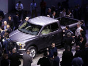 Journalists surround the new F-150 with a body built almost entirely out of aluminum at the North American International Auto Show in Detroit on Monday.