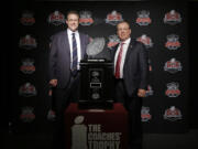 Auburn head coach Gus Malzahn, left, and Florida State head coach Jimbo Fisher pose with The Coaches' Trophy during a news conference for the NCAA BCS National Championship college football game Sunday, Jan. 5, 2014, in Newport Beach, Calif. Florida State plays Auburn on Monday, Jan. 6, 2014. (AP Photo/David J.