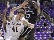 Portland State's DaShaun Wiggins (23) goes to the basket as Montana's Andy Martin (41) defends during the Big Sky quarterfinals in Ogden, Utah.