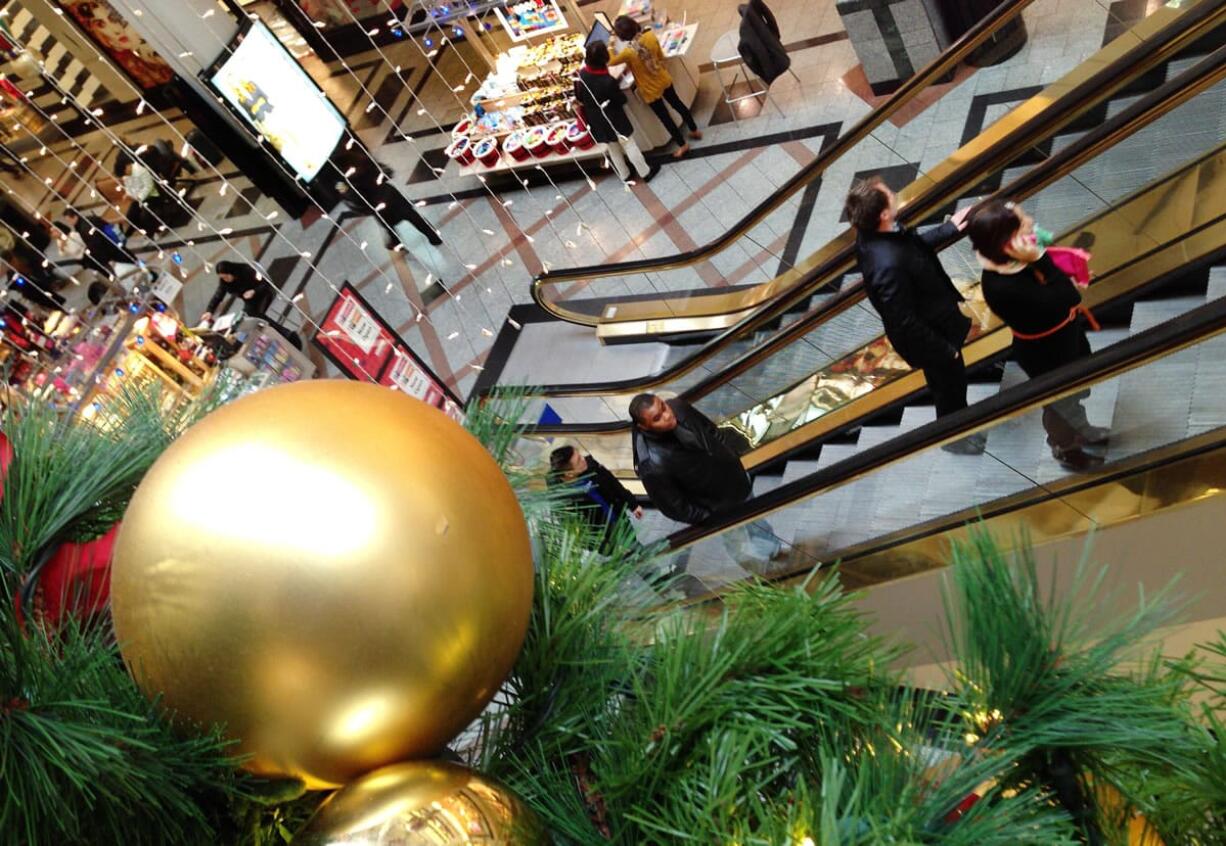 Shoppers shop at a mall in Cambridge, Mass.,