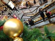 Shoppers shop at a mall in Cambridge, Mass.,