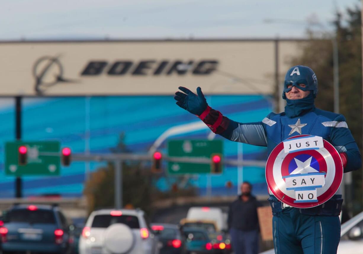 Dressed as Captain America, James White, a machinist with 17 years experience at Boeing encourages members to vote no during the shift change in Everett in November.