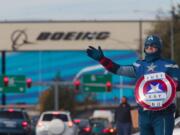 Dressed as Captain America, James White, a machinist with 17 years experience at Boeing encourages members to vote no during the shift change in Everett in November.