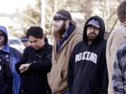 Boeing machinists stand in a line of several hundred as they wait to cast their ballots on Friday in Everett.