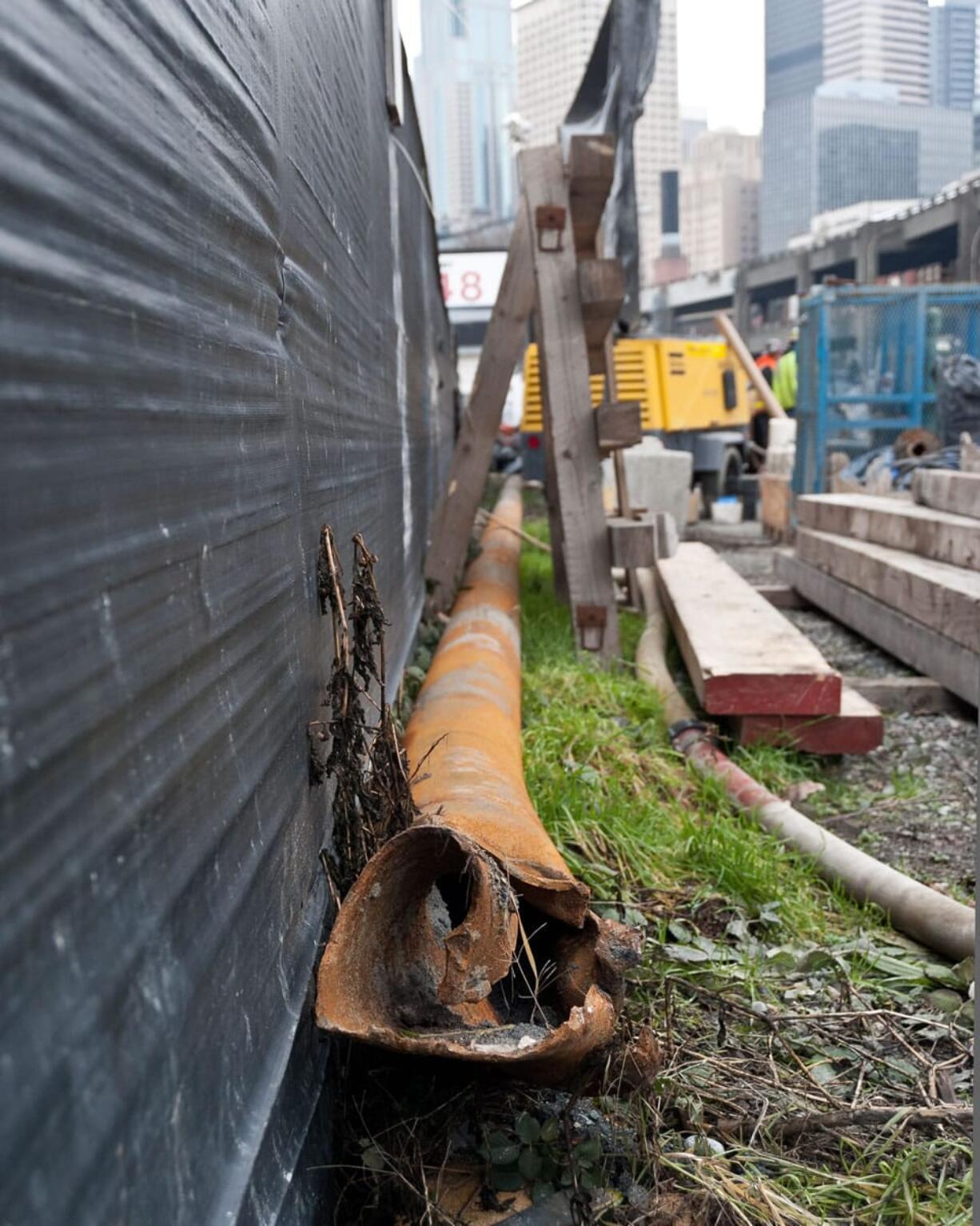 A 57-foot section of steel pipe lies in the Highway 99 tunnel construction yard after being pulled from the ground after it was struck by tunneling machine Bertha a month earlier, in Seattle on Jan.