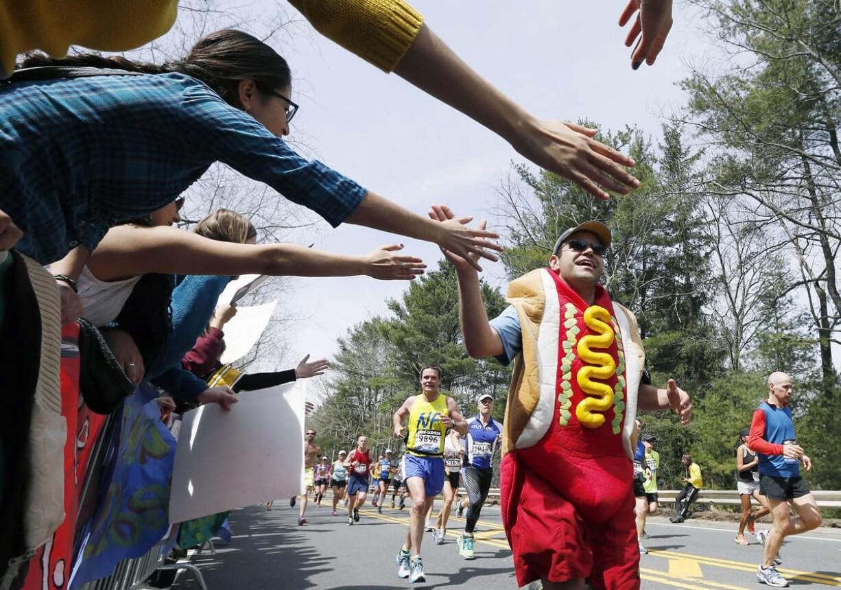 A man dressed as a hot dog runs in the 2013 Boston Marathon.