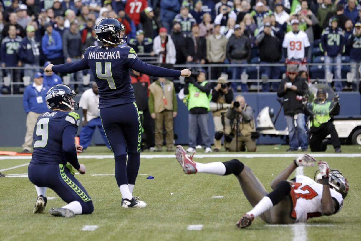 Seattle Seahawks' kicker Steven Hauschka (4) watches as his game-winning field goal is good in overtime as holder Jon Ryan watches the ball and Tampa Bay Buccaneers' Johnthan Banks, right, goes to the turf in an NFL football game Sunday, Nov. 3, 2013, in Seattle. The Seahawks won 27-24 in overtime.