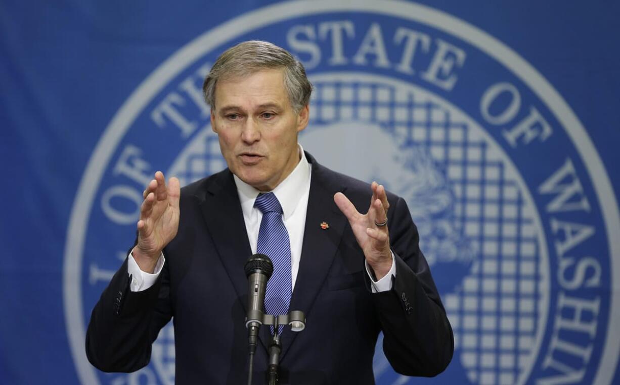 Washington Gov. Jay Inslee talks to reporters about his supplemental budget Tuesday at the Capitol in Olympia.