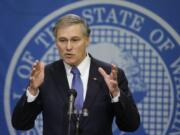 Washington Gov. Jay Inslee talks to reporters about his supplemental budget Tuesday at the Capitol in Olympia.