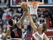 Portland's Robin Lopez, right, blocks a shot by Chicago's Derrick Rose during the first half Friday.