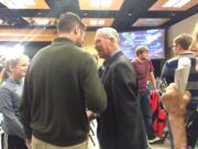 Clark County chair candidate Marc Boldt, center, talks to Vancouver City Councilor Bart Hansen, left, on Tuesday night in Vancouver shortly after preliminary election results were revealed.