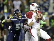 Seattle Seahawks outside linebacker Bruce Irvin (51) pressures Arizona Cardinals quarterback Carson Palmer, right, in the first half of an NFL football game, Sunday, Nov. 15, 2015, in Seattle.