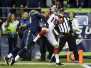 Arizona Cardinals wide receiver Michael Floyd (15) makes a catch for the go-ahead touchdown around the defense of Seattle Seahawks cornerback Byron Maxwell.