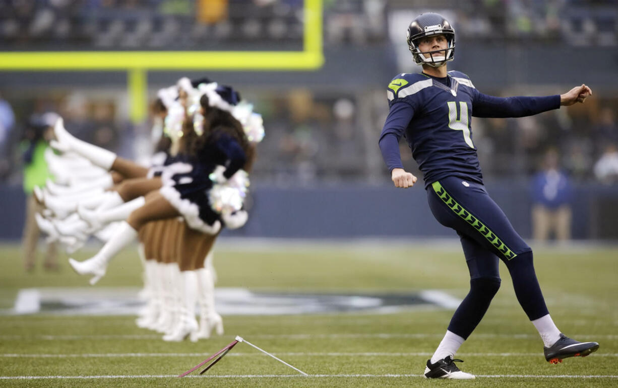 Seattle Seahawks kicker Steven Hauschka warms up near Seattle Seahawks Sea Gals cheerleaders before Sunday's game.