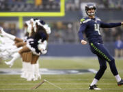 Seattle Seahawks kicker Steven Hauschka warms up near Seattle Seahawks Sea Gals cheerleaders before Sunday's game.