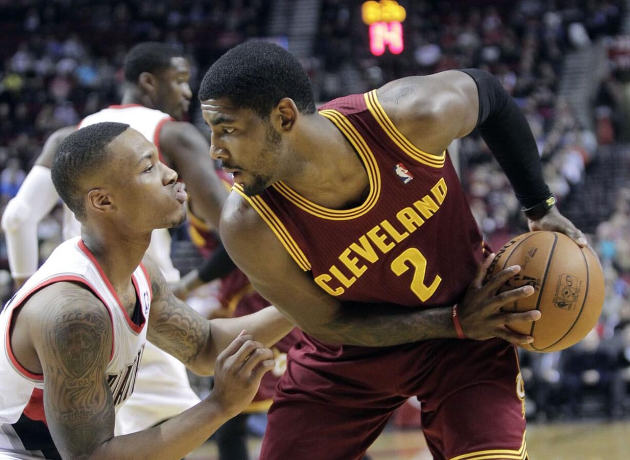 Portland's Damian Lillard, left, defends against Cleveland's Kyrie Irving on Wednesday at the Moda Center in Portland.