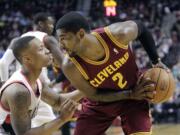 Portland's Damian Lillard, left, defends against Cleveland's Kyrie Irving on Wednesday at the Moda Center in Portland.