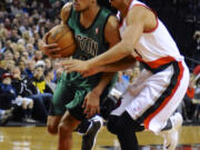 Boston Celtics' Avery Bradley, left, drives against Portland Trail Blazers' CJ McCollum during the first half Saturday.