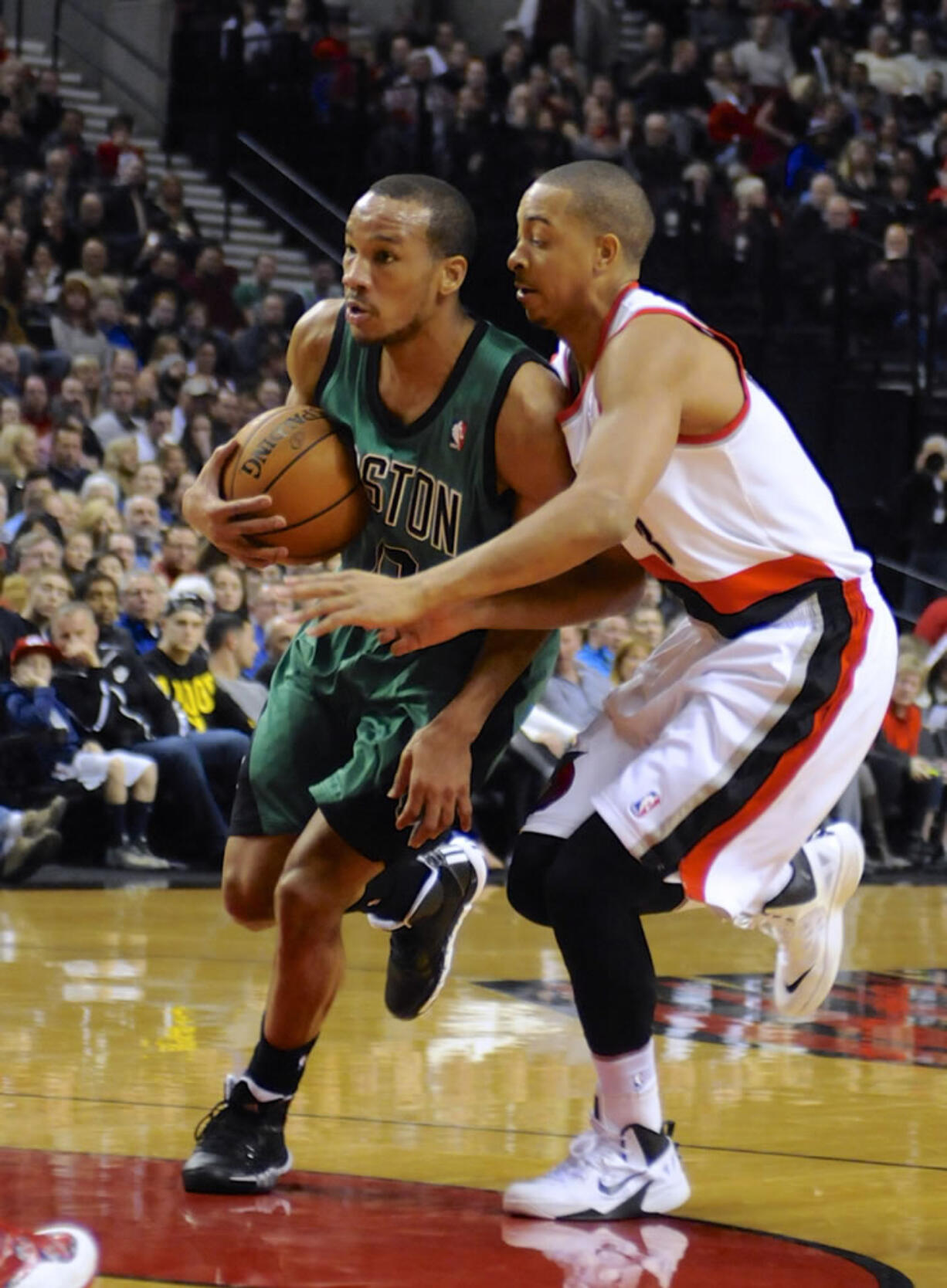 Boston Celtics' Avery Bradley, left, drives against Portland Trail Blazers' CJ McCollum during the first half Saturday.