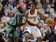 Boston Celtics' Brandon Bass (30) defends against Portland Trail Blazers' LaMarcus Aldridge (12) during the first half of an NBA basketball game in Portland, Ore., Saturday, Jan. 11, 2014.