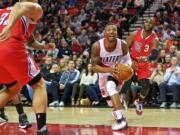 Portland Trail Blazers guard Damian Lillard, front right, drives to the basket past Los Angeles Clippers guard Chris Paul, right, during the first half of an NBA basketball game in Portland, Ore., Friday, Nov. 20, 2015.