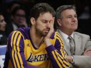 Los Angeles Lakers' Pau Gasol, of Spain, covers his face while sitting on the bench during the second half of an NBA basketball game against the Los Angeles Clippers on Thursday, March 6, 2014, in Los Angeles. The Clippers won 142-94. (AP Photo/Jae C.