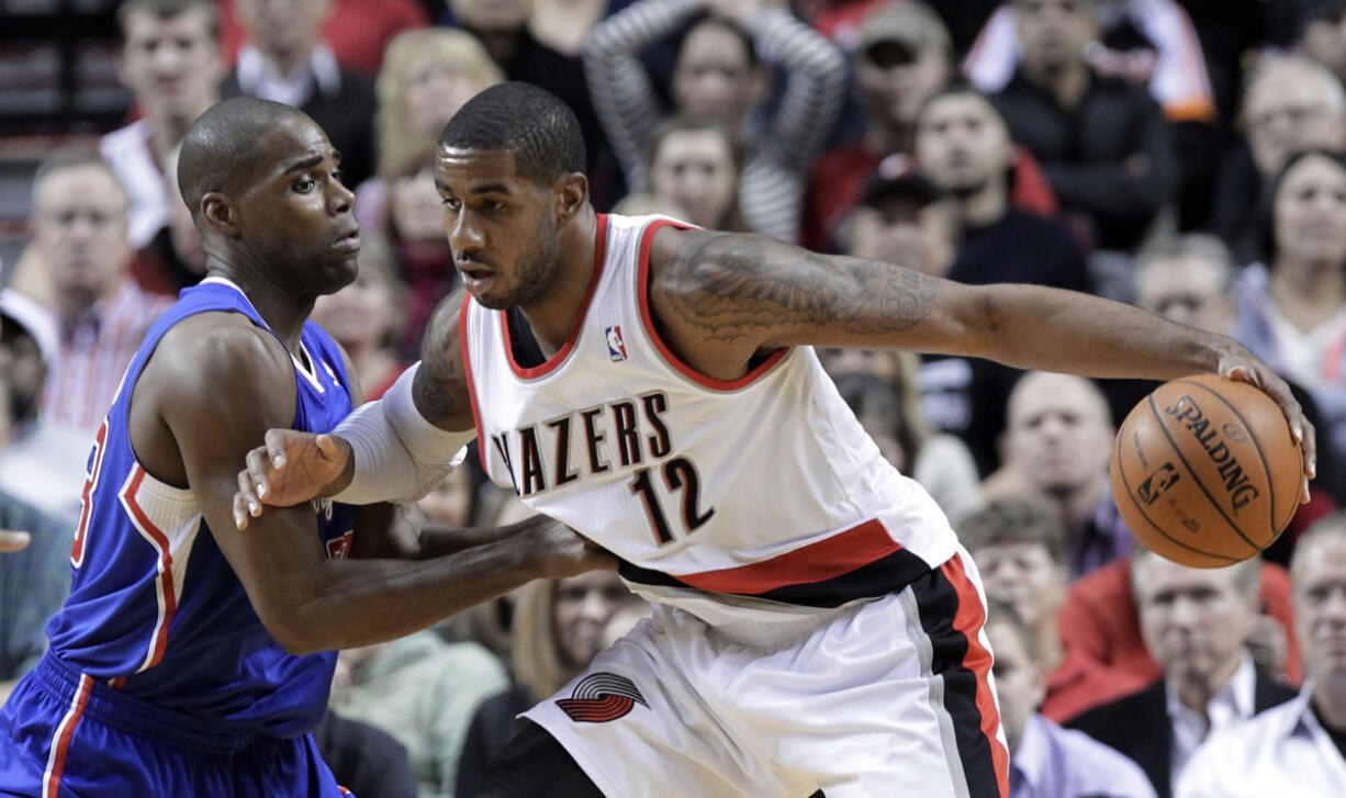 Portland Trail Blazers forward LaMarcus Aldridge, right, works the ball in on Los Angeles Clippers forward Antawn Jamison during the first half Thursday.