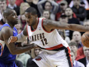 Portland Trail Blazers forward LaMarcus Aldridge, right, works the ball in on Los Angeles Clippers forward Antawn Jamison during the first half Thursday.