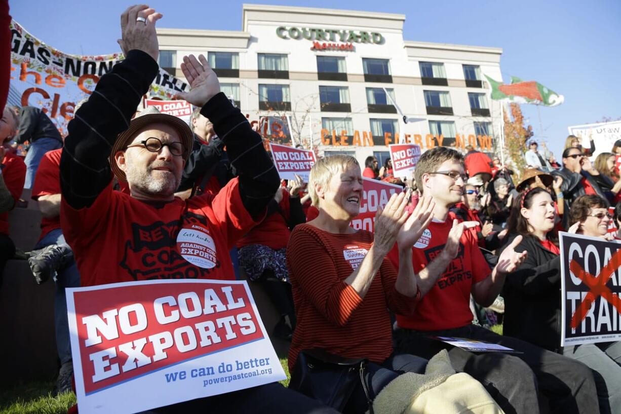 Russ Childers, left, of Seattle, sits among other protesters as they demonstrate against trains carrying coal for export moving through Washington state on Thursdayin Tacoma. The protest occurred prior to the fifth and final public hearing on the environmental impact statement for a proposed coal export terminal in Longview.