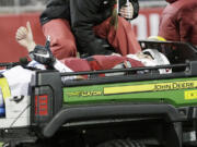 Washington State quarterback Luke Falk (4) gestures as he is carted off the filed after being injured during the second half of an NCAA college football game against Colorado, Saturday, Nov. 21, 2015, in Pullman, Wash. Washington State won 27-3.