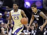 Washington's C.J. Wilcox (23) drives in front of Colorado's Dustin Thomas in the second half Sunday. Wilcox led all scorers with 31 points in Washington's 71-54 Pac-12 Conference victory.