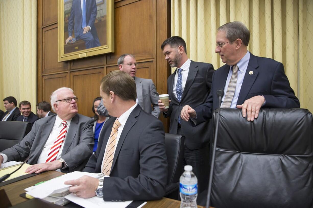 House Judiciary Committee Chairman Rep. Bob Goodlatte, R-Va., right, joined by committee counsel Robert Parmiter, seated at center, and Rep. Jim Sensenbrenner, R-Wisc., chairman of the House subcommittee on Crime, Terrorism, Homeland Security and Investigations, far left, gather on Capitol Hill in Washington on Wednesday as the panel met to approve rare bipartisan legislation that would reduce prison time for some nonviolent drug offenders. The aim of the bipartisan bills is to reduce overcrowding in the nation&#039;s prisons, save taxpayer dollars and give some nonviolent offenders a second chance while keeping the most dangerous criminals in prison.  (AP Photo/J.