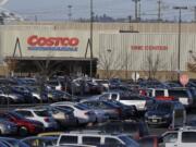 Cars fill the parking lot of a Costco store, Tuesday, Nov. 24, 2015, in Seattle. Health authorities say chicken salad from Costco has been linked to at least one case of E. coli in Washington state.  (AP Photo/Ted S.