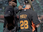 San Francisco Giants former player Barry Bonds, left, chats with catcher Buster Posey during batting practice.